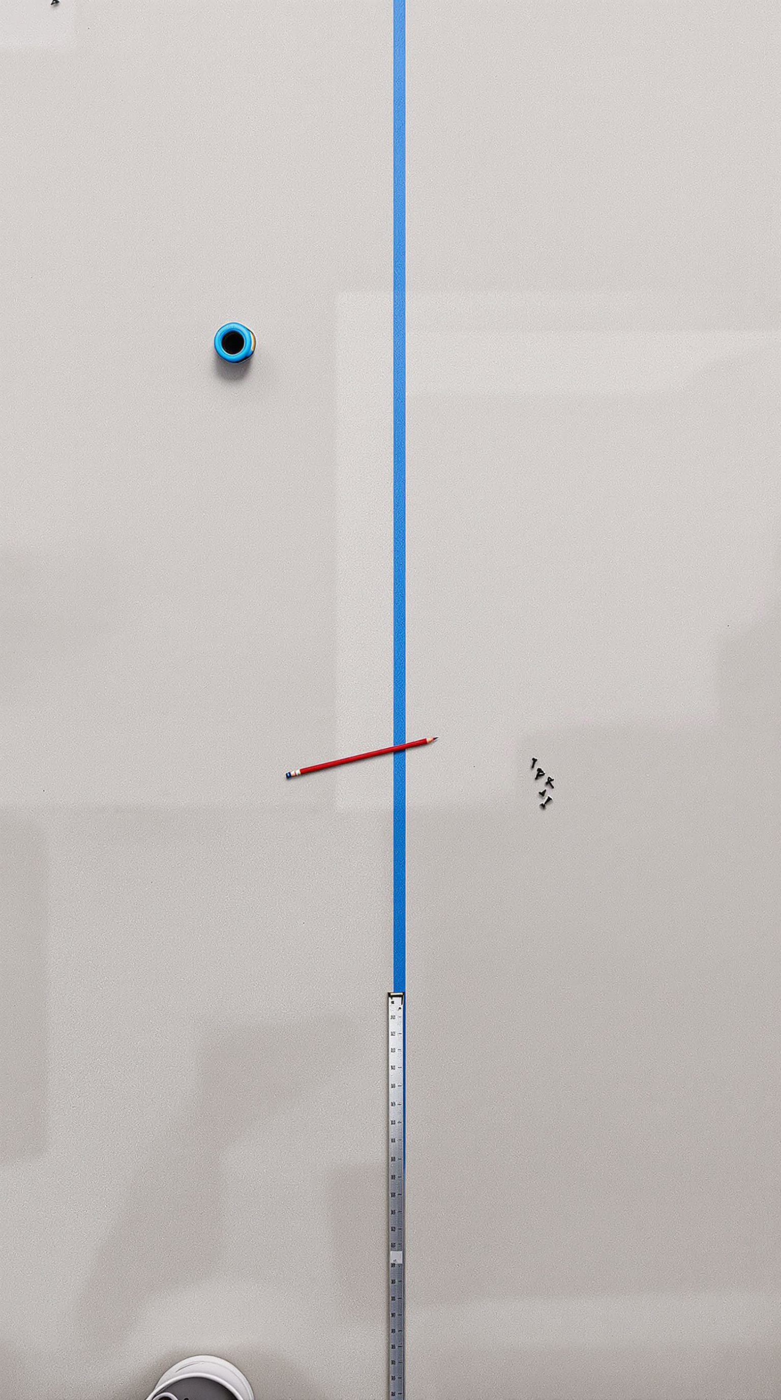 A bare cement screed floor in an unfinished UAE interior, photographed from directly overhead.